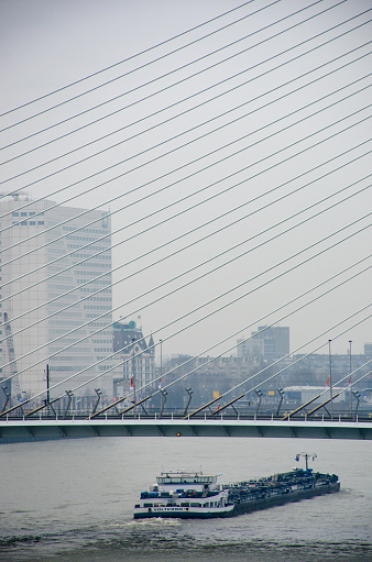 Rotterdam  Netherlands - 2 April 2018:  Cargo Ship with Erasamus Bridge in Background