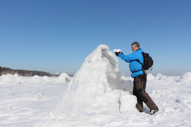 istock Man building an igloo on a snowy reservoir in winter 948894118
