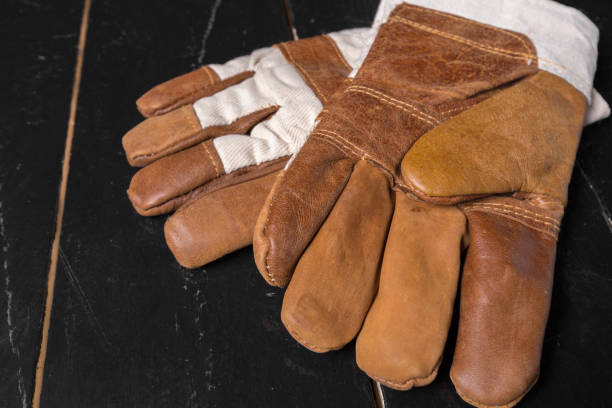 istock Construction gloves on a wooden background. close up 948894742