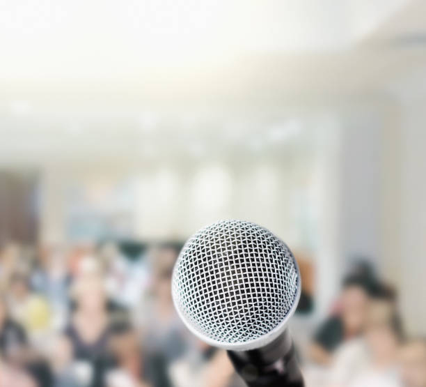 istock Microphone waits in front of defocused audience 948894754