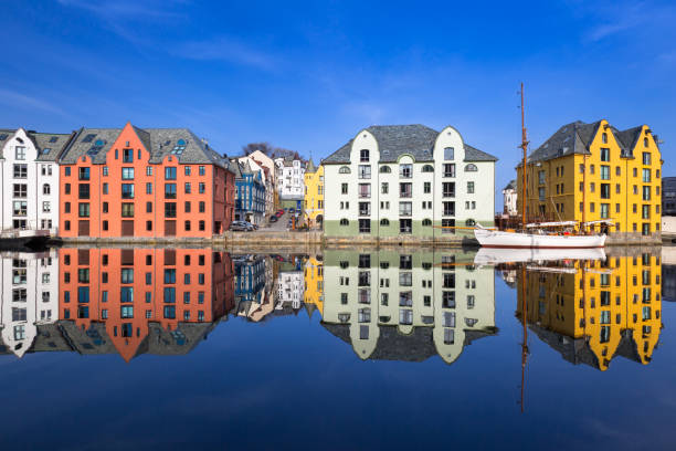 Architecture of Alesund town reflected in the water, Norway