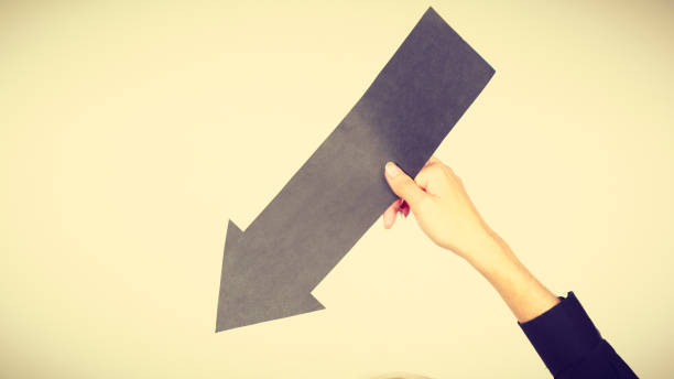 istock Man holding black arrow pointing right 948900746