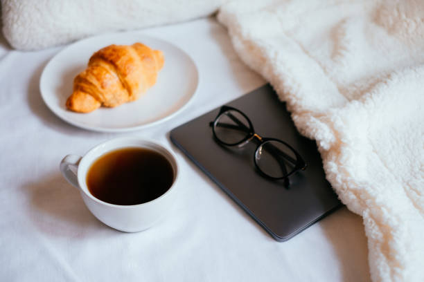 istock Coffee and croissant in bed 948905752