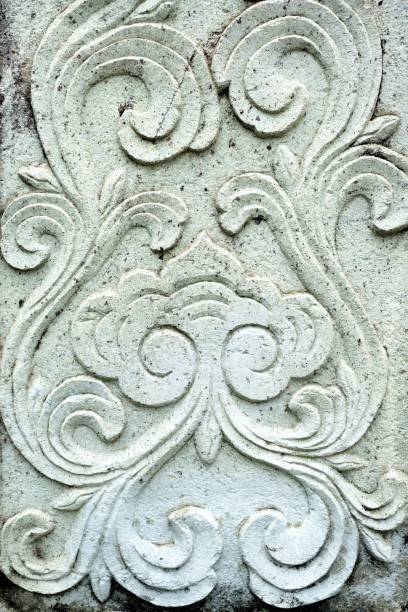 istock Vintage Thai Sculpture on wall on stone wall. 948910396