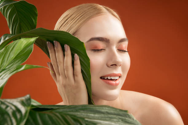 istock Well cared woman contacting with plant 948911098