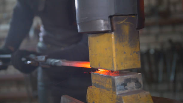 istock Molten metal is processed under pressure in the hands of a blacksmith 948920482
