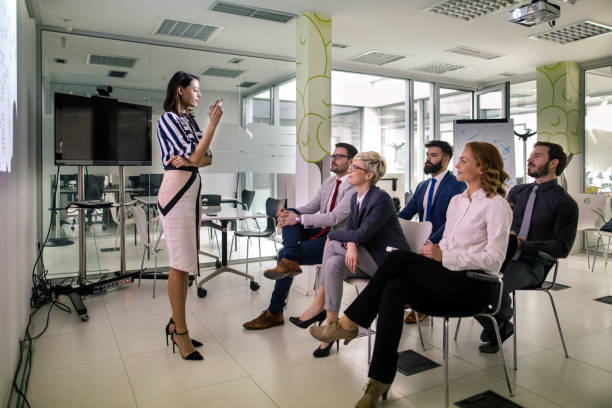 istock Woman giving a presentation to her team 948920652