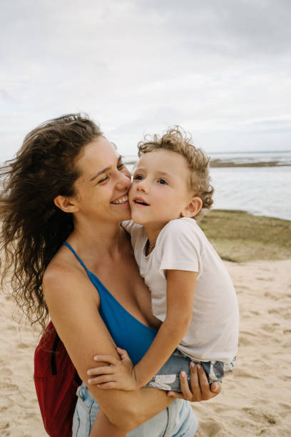 istock Mother playing with son on the beach 948920922