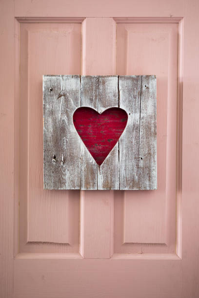 St. Valentine handmade wooden heart panel on the door, postcard concept