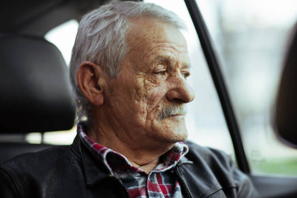 istock Senior man on back car seat 948921692