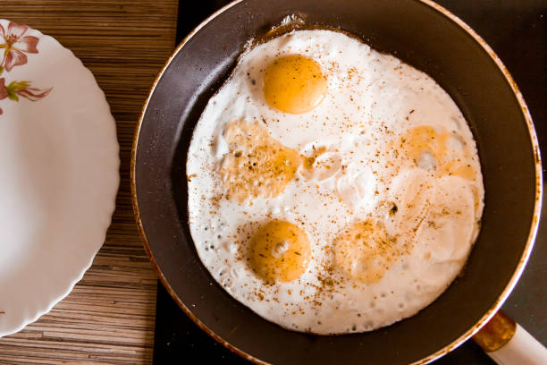 istock Cooking eggs in a frying pan at home on the stove 948931122