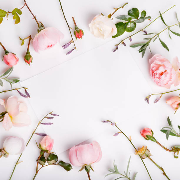 istock Festive flower composition on the white wooden background. Overhead view 948931488