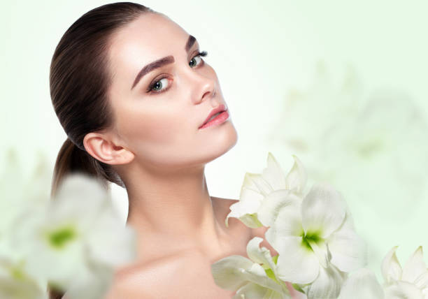istock beauty and spa, ffemale face with a flower 948937598