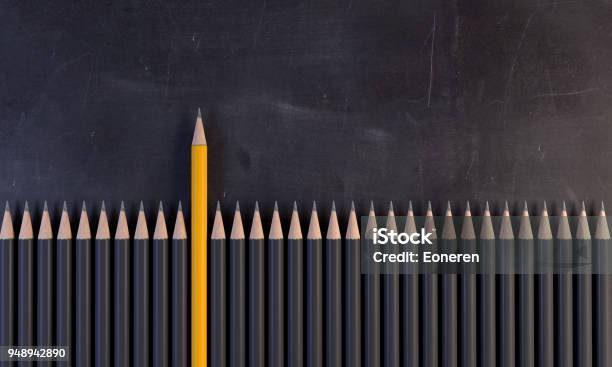 Orange Colored Pencil Standing Out From The Crowd Stock Photo - Download Image Now - Standing Out From The Crowd, Pencil, Individuality