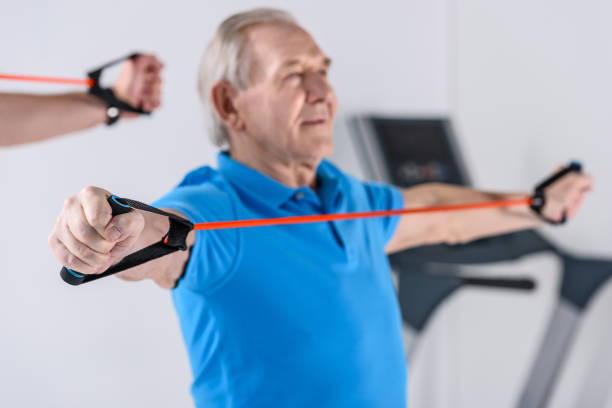 istock selective focus of senior man exercising with rubber tape 948946626
