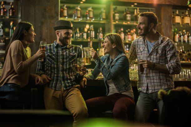 istock Young happy friends talking while enjoying in beer at a pub. 948947260