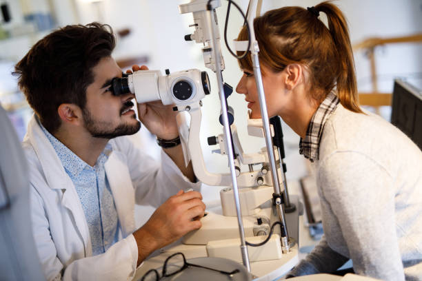 istock Young woman having her eyes examined by optometrist. 948962908