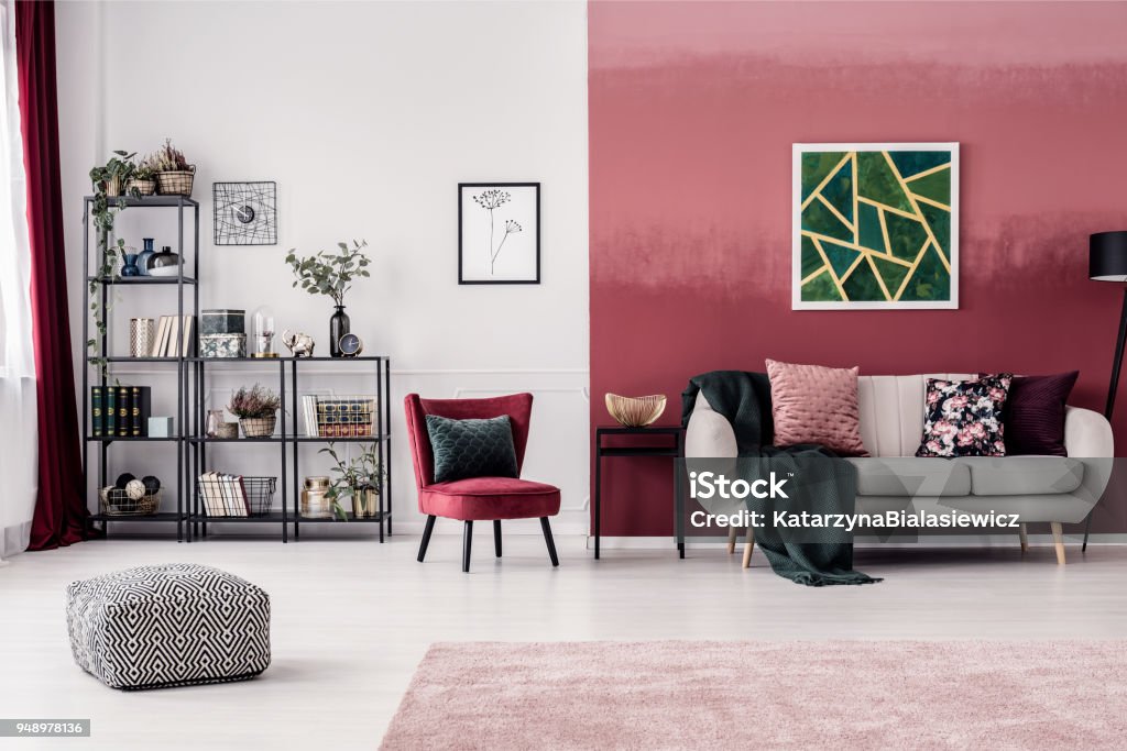 Living room with red wall Cozy living room interior with red, ombre wall, bookcase and white sofa Living Room Stock Photo