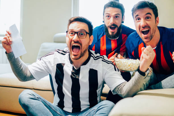 istock Happy male football supporters shouting from joy 948987688