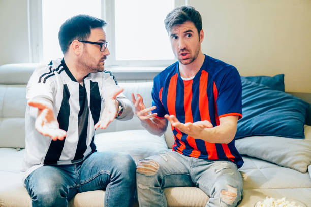 istock Nervous male football supporters discussing game using hand gestures 948988206