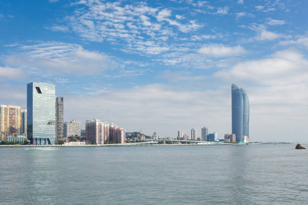 China Xiamen landmark landscape：Chic shape of the skyscraper and the Chinese national hero Zheng Chenggong statue opposite the sea, is the landmark of Xiamen City.