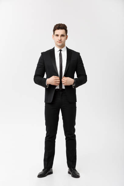 istock Business Concept: Handsome Man Happy Smile Young Handsome Guy in smart suit posing over Isolated Grey Background. 949004486