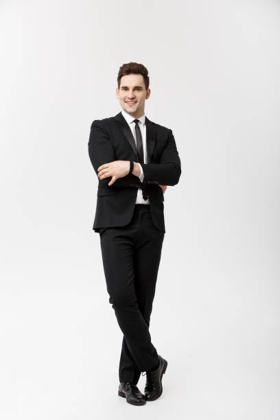 istock Business Concept: Handsome Man Happy Smile Young Handsome Guy in smart suit posing over Isolated Grey Background. 949004726