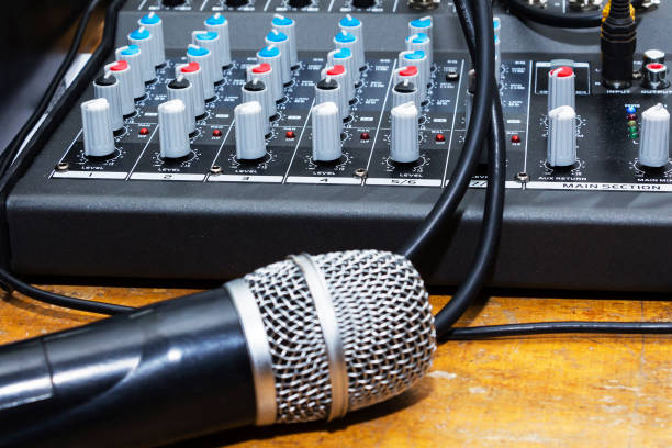 istock Professional condenser studio microphone over the musician blurred background and audio mixer, Musical instrument Concept. 949033326