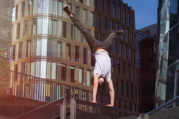 istock Young man doing handstand in the city 949033406