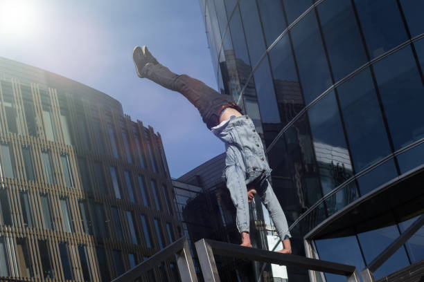 istock Young man doing handstand in the city 949033426