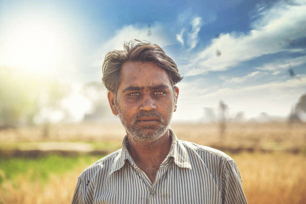 istock Portrait of Farmer standing in wheat field 949035896