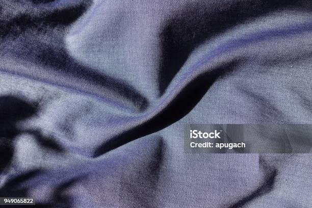 Blue Jeans Fabric Shot With Violet In Soft Folds Stock Photo - Download Image Now - Blue, Casual Clothing, Close-up