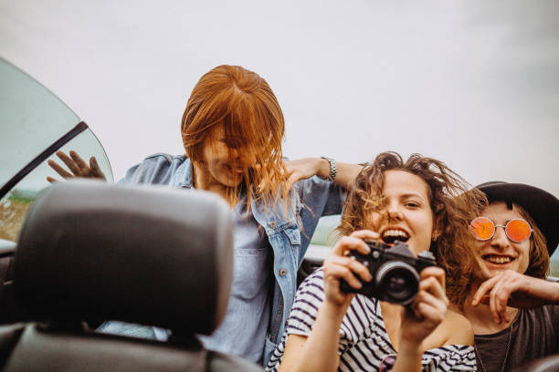 istock Excited group of friends having fun in a convertible 949071248