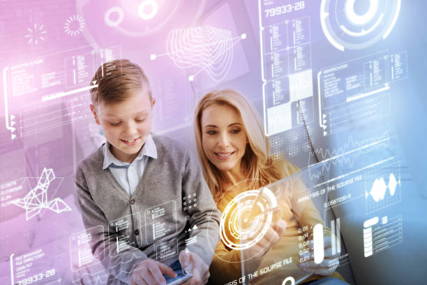 istock Analytics manager looking at the transparent screen and her son sitting near 949071502