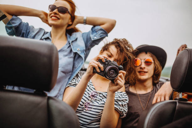 istock Excited group of friends having fun in a convertible 949071830