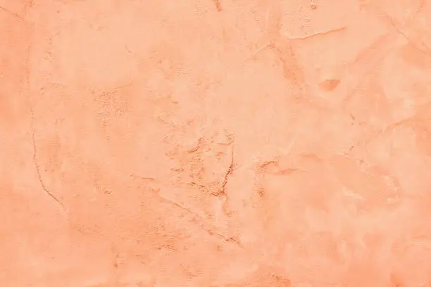 Photo of Peach color painted old cement plaster wall texture