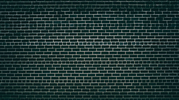 istock Emerald black brick wall with convex mortar joints for background 949077886