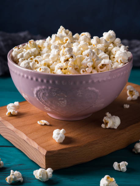 istock Popcorn in pink bowl on dark background 949078582