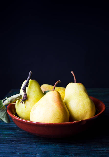 istock Pears on dark wooden background 949079214