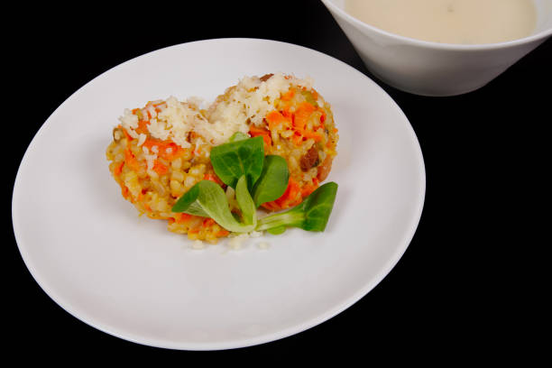 istock Risotto with carrot and cheese on black 949090602