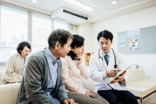 Doctor Explaining Test Results To Patients stock photo