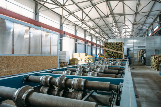 istock Sandwich manufactory panel production line. Equipment machine tools and roller conveyor in large hangar or workshop 949098664