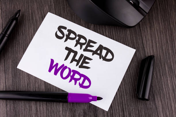 istock Handwriting text writing Spread The Word. Concept meaning Run advertisements to increase store sales many fold written on White Sticky Note Paper on the wooden background Mouse Markers 949099098