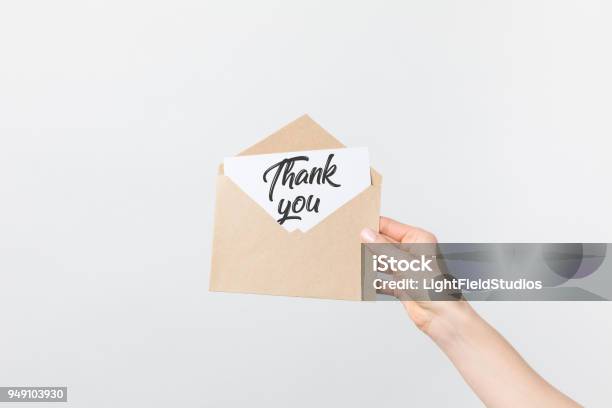 Partial View Of Woman Holding Kraft Envelope With Thank You Card Isolated On White Stock Photo - Download Image Now