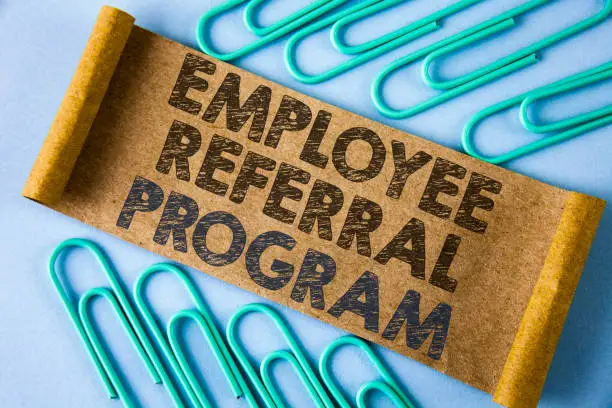 Photo of Text sign showing Employee Referral Program. Conceptual photo strategy work encourage employers through prizes written on Folded Cardboard paper piece on plain blue background within Paper Pins.