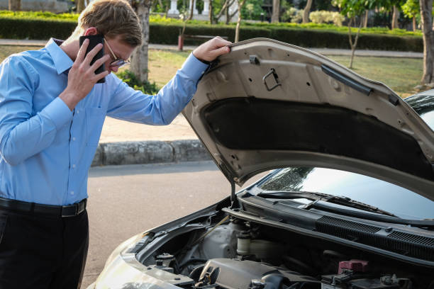 istock male agent examining engine for claiming auto insurance. caucasian man calling for assistance for car damaged by traffic accident 949107830