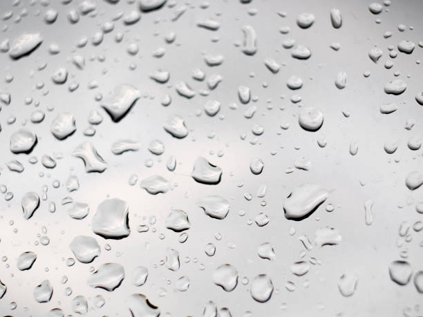 istock rain droplets on the glass and white background 949110834