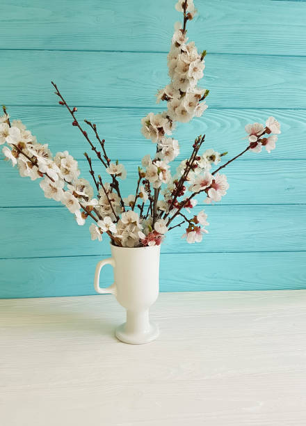istock cherry blossom branch in a vase on a colored wooden background 949112298