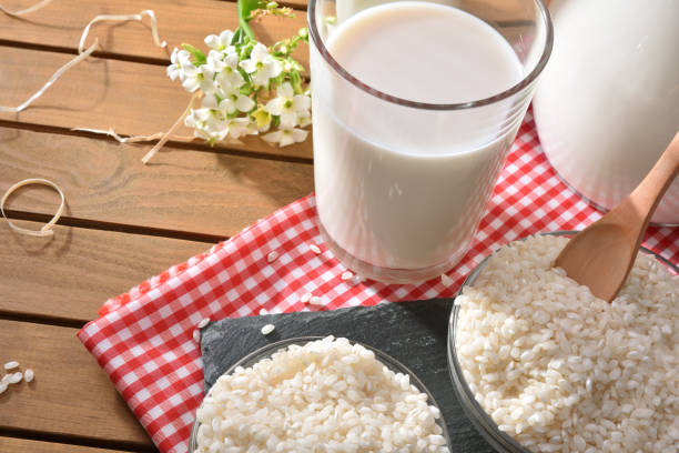 istock Composition with rice drink in containers in the field elevated 949114044