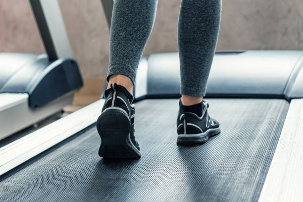 istock woman legs on treadmill 949114558